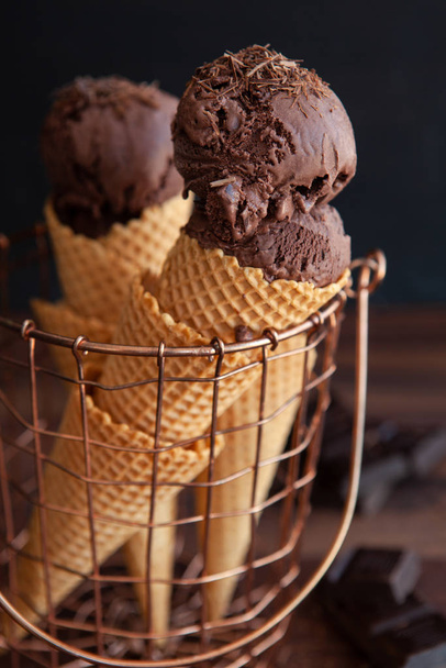 Waffled cones in basket with rich dark chocolate ice cream - Zdjęcie, obraz