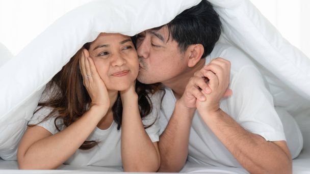 asian mature couple happy with romantic moment together under bl - Zdjęcie, obraz