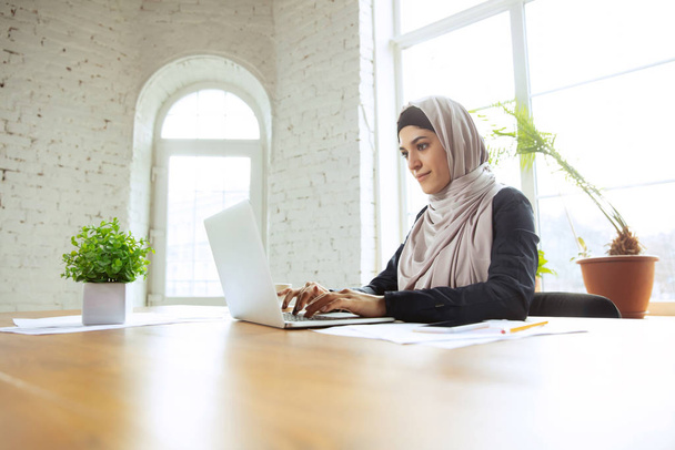 Portrait of a beautiful arabian businesswoman wearing hijab while working - Fotoğraf, Görsel