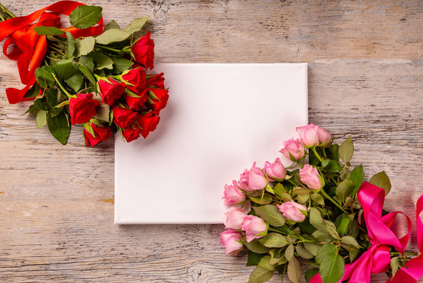 Valentines day or Mothers day greeting card and roses over wooden table - Foto, immagini