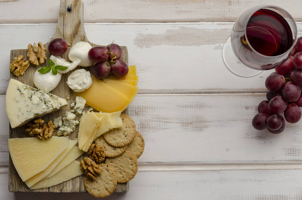 juusto levy valkoisella pohjalla hilloa pähkinät ja evästeet
 - Valokuva, kuva