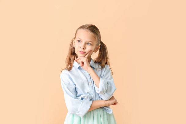 Thoughtful little girl on color background - Photo, image