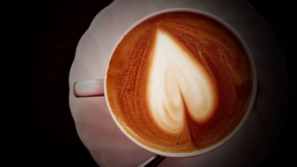 Cappuccino coffee heart shape in white cup. - 写真・画像