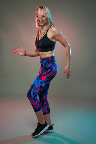 Fitness model doing aerobic exercises and dancing, studio shot - Valokuva, kuva