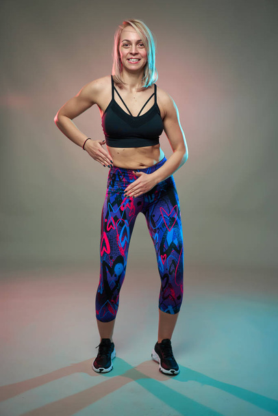 Fitness model doing aerobic exercises and dancing, studio shot - Φωτογραφία, εικόνα