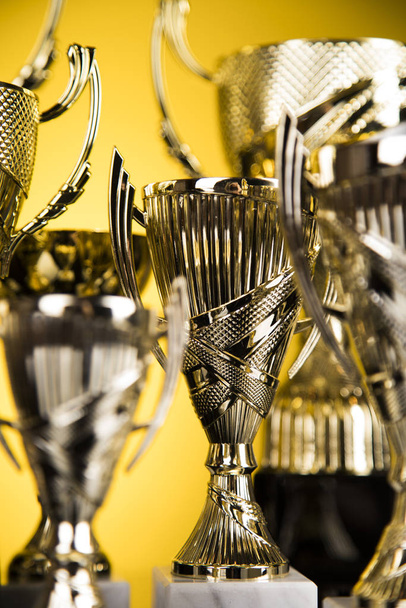 Cups of winners award on white podium, sport background - Zdjęcie, obraz