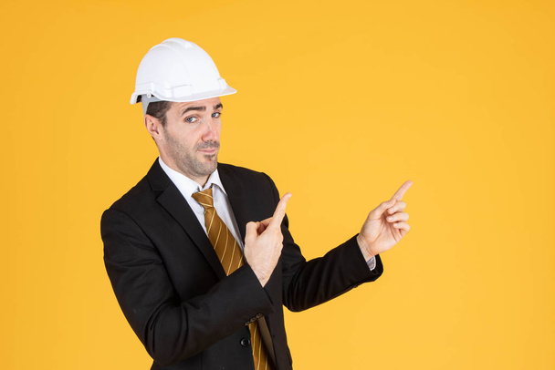 Young handsome businessman wears suit and construction helmet on - Foto, immagini