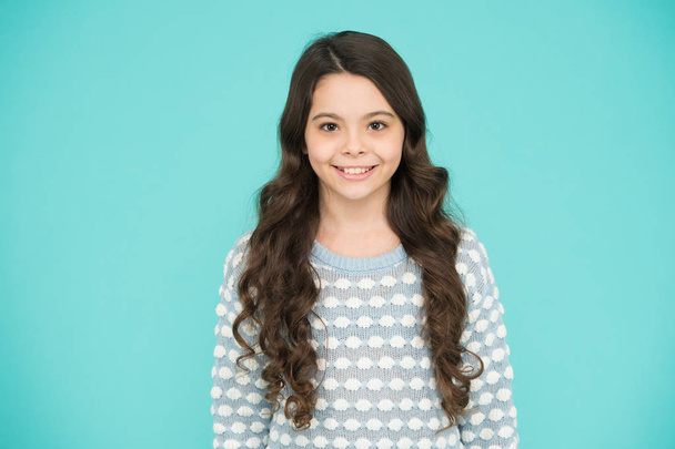 Little girl blue background. Smiling small girl with long hair. Beauty and health. Childhood and girlhood. International childrens day. Child care. Happy childhood. Beautiful kid. Emotional girl - Foto, imagen