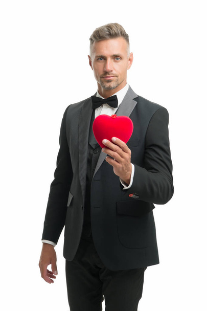 Romantic surprise. Celebrate valentines day. Prepare gift for valentine. Love date anniversary. Generous man. Man mature handsome guy wear elegant suit hold red heart. Valentines day celebration - Photo, image