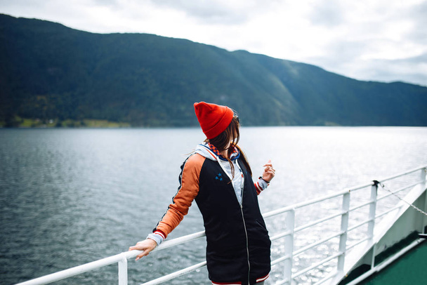Smiling girl on a ferry. Young woman enjoys a ferry ride or ship, sailing to the island tourist destination on summer vacation in sunny day. Travelling, lifestyle, adventure, concept. - Foto, imagen