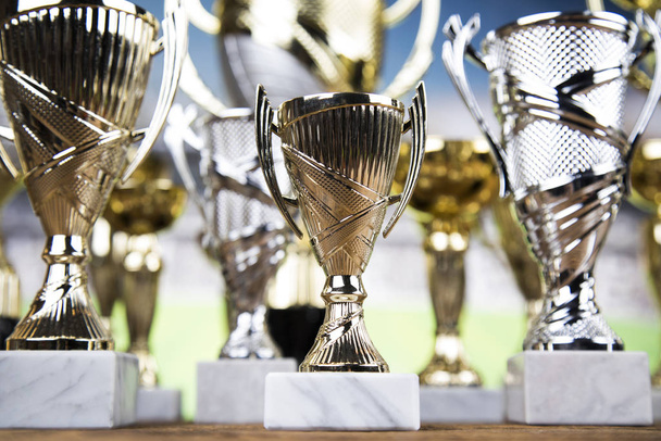 Cups of winners award on white podium, sport background - Zdjęcie, obraz