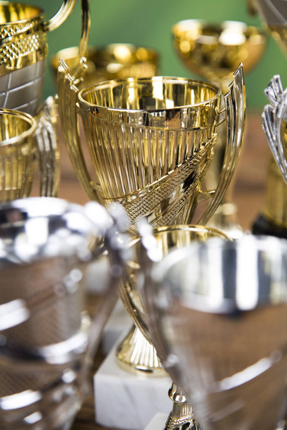 Cups of winners award on white podium, sport background - 写真・画像