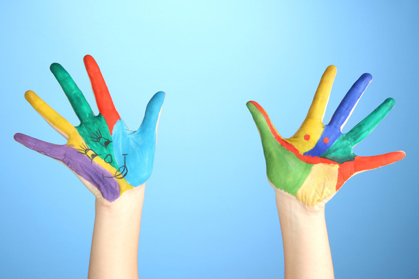 Painted hands with smile on blue background - Foto, Imagem