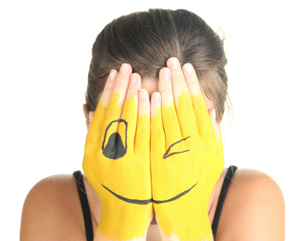 Portrait of girl hiding her face under smile mask isolated on white - Fotó, kép