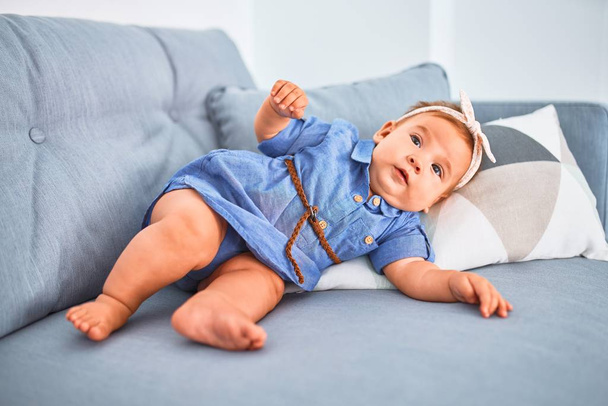 Adorable baby lying down on the sofa at home. Newborn relaxing and resting comfortable - Fotoğraf, Görsel