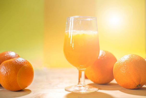 glass of fresh orange juice with fresh fruits on wooden table healthy concept - Foto, afbeelding