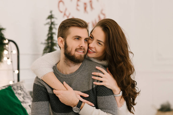 Attractive and loving man and a girl, the concept of a Christmas love story - Foto, Imagem