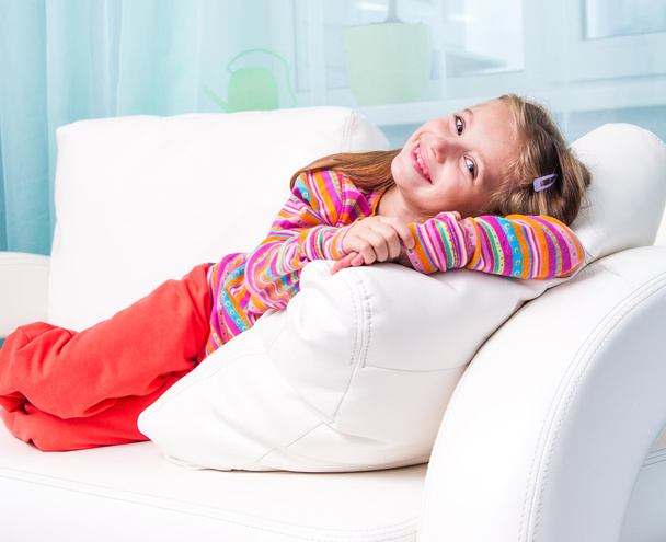 little girl on a white sofa - Фото, зображення