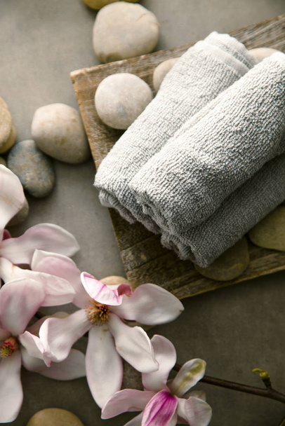 Spa and wellness. Fresh towels  with magnolia flower . Spa treatment. Overhead flatlay - Fotoğraf, Görsel