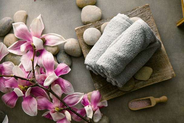 Spa and wellness. Fresh towels  with magnolia flower . Spa treatment. Overhead flatlay - Fotoğraf, Görsel