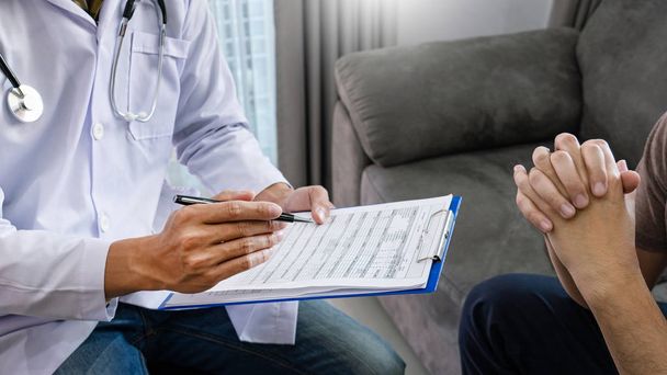 Doctor explaining for patient and showing medical records informations and diagnosis patient symptoms in a consultation and medical insurance concept - Photo, Image