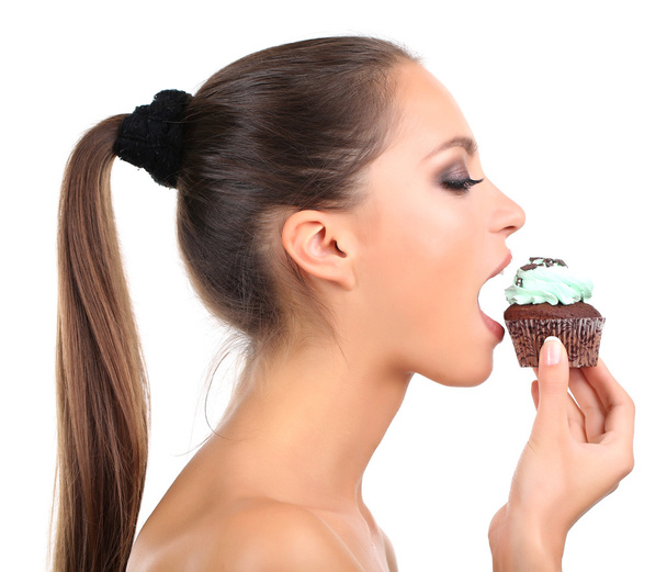 Portrait of beautiful young girl with chocolate cupcake isolated on white - Фото, изображение