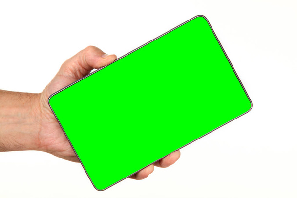Human hand holds a modern smartphone with a blank chromakey screen in a palm. Technology and advertising concept. Detailed closeup studio shot isolated on abstract blurred white background - Photo, Image