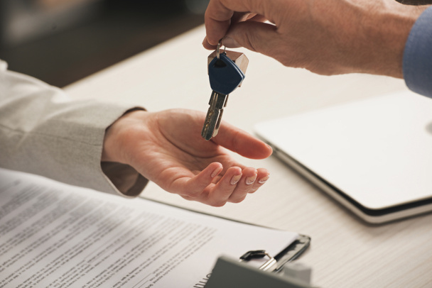 cropped view of man giving keys to client  - Photo, Image
