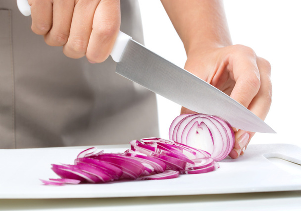Cook is chopping onion - 写真・画像
