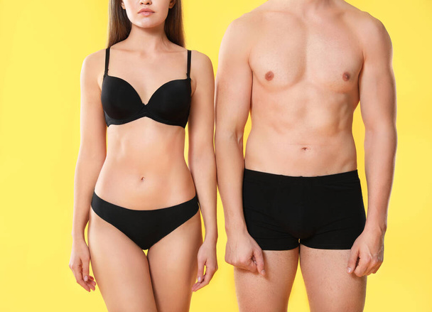 Young couple in underwear on color background - Fotó, kép