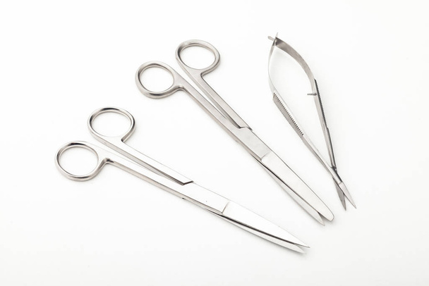 Steel surgical tools and laboratory equipment isolated on a white background. Professional clinic instruments. Medical, surgery, ambulance and veterinarian concept. Closeup with soft selective focus - Fotografie, Obrázek
