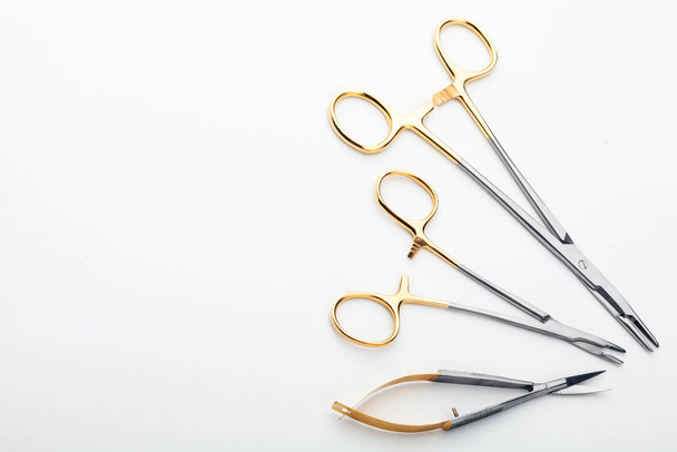 Steel surgical tools and laboratory equipment isolated on a white background. Professional clinic instruments. Medical, surgery, ambulance and veterinarian concept. Closeup with soft selective focus - Zdjęcie, obraz