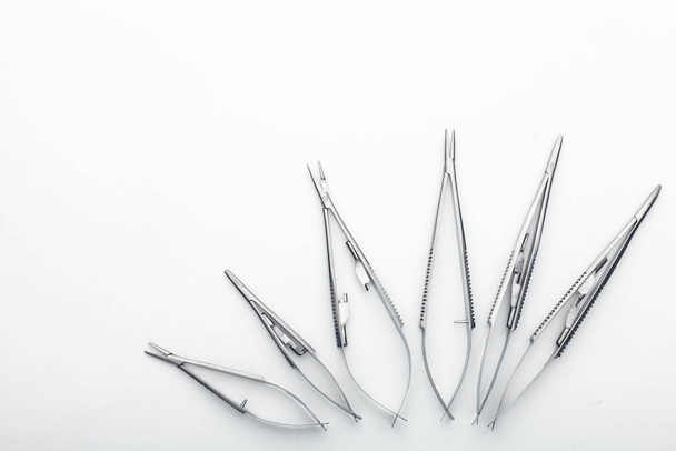 Steel surgical tools and laboratory equipment isolated on a white background. Professional clinic instruments. Medical, surgery, ambulance and veterinarian concept. Closeup with soft selective focus - Foto, Imagem
