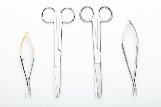 Steel surgical tools and laboratory equipment isolated on a white background. Professional clinic instruments. Medical, surgery, ambulance and veterinarian concept. Closeup with soft selective focus - Foto, afbeelding