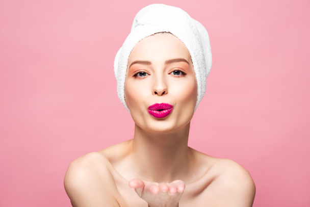 happy naked woman in white towel sending air kiss isolated on pink  - Photo, Image