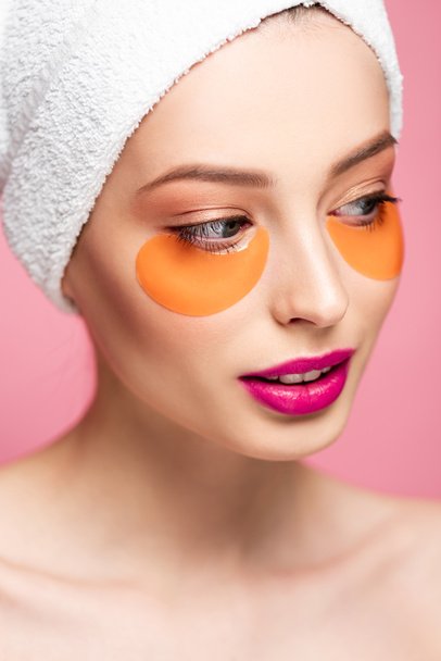 attractive naked girl with eye patches on face looking away isolated on pink  - Photo, Image