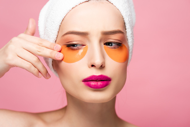 pretty girl touching face with eye patches isolated on pink  - Photo, Image