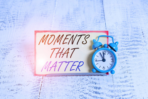Записка, показывающая моменты, которые имеют значение. Бизнес-концепция для значимых позитивных счастливых запоминающихся важных времен Буферные часы наклонены над буферной проволокой перед блокнотом
 - Фото, изображение