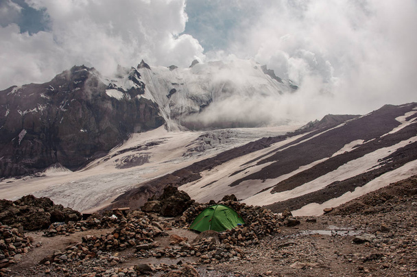 Tourist tent standing among rocks in mountains - Φωτογραφία, εικόνα