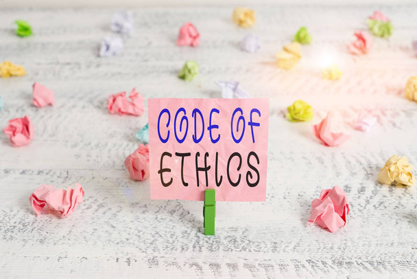 Handwriting text Code Of Ethics. Conceptual photo basic guide for professional conduct and imposes duties Green clothespin white wood background colored paper reminder office supply - Photo, Image