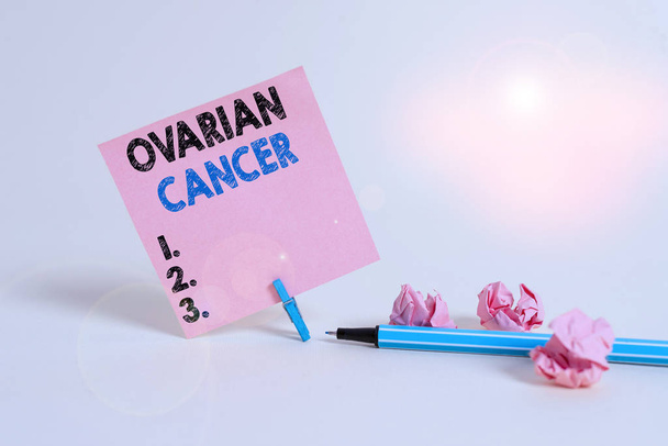 Text sign showing Ovarian Cancer. Business photo showcasing any cancerous growth that forms in the tissues of the ovary Plain note paper and stationary placed above soft pastel colour backdrop - Photo, Image
