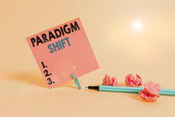 Text sign showing Paradigm Shift. Business photo showcasing fundamental change in approach or underlying assumptions Plain note paper and stationary placed above soft pastel colour backdrop - Photo, Image
