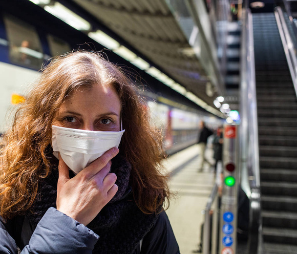 woman wearing surgical mask in crowd coronavirus - Photo, image