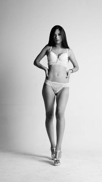 Girl in white lingerie and high heels posing on white background.  - Foto, Imagem