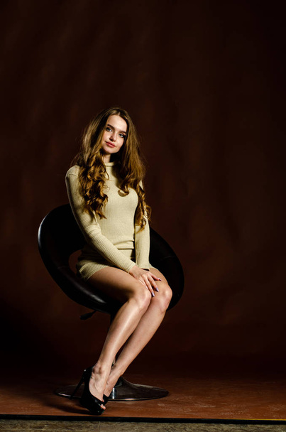 sensual attractive woman in shiny dress posing on black background  - Fotografie, Obrázek