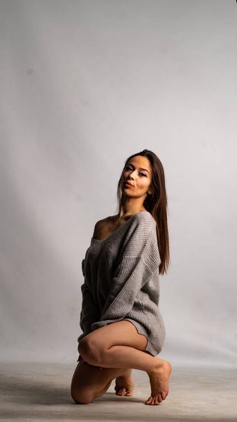 beautiful sexy girl, posing gray dress, white background - Photo, Image