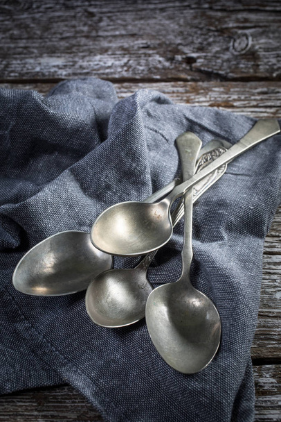 A few old silver spoons. - Фото, изображение