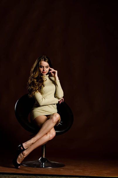 sensual attractive woman in shiny dress posing on black background  - Valokuva, kuva
