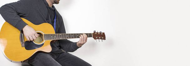 man playing acoustic guitar sitting on bar stool, musical instrument, isolated background - Photo, Image