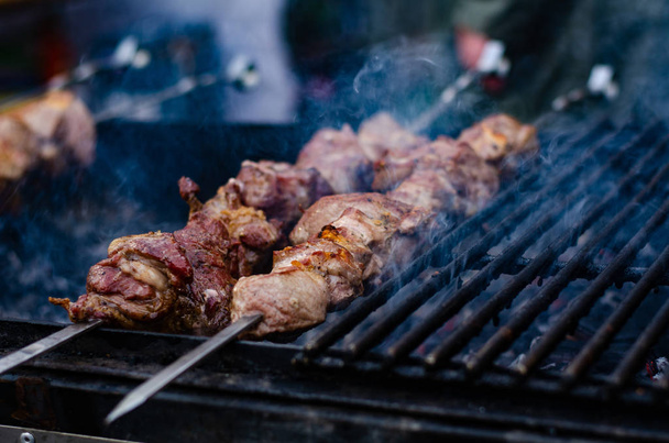 closeup of some meat skewers being grilled in a barbecue - Photo, Image